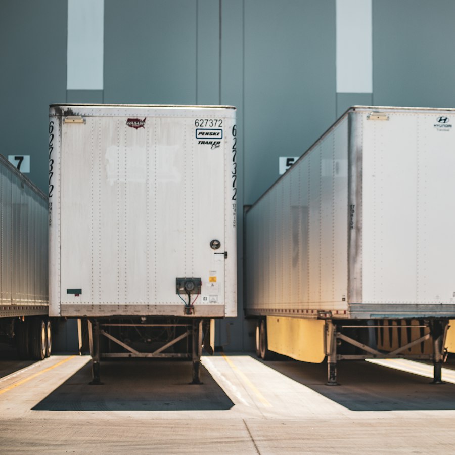 Semi trailers backed up to warehouse dock doors for cross-docking