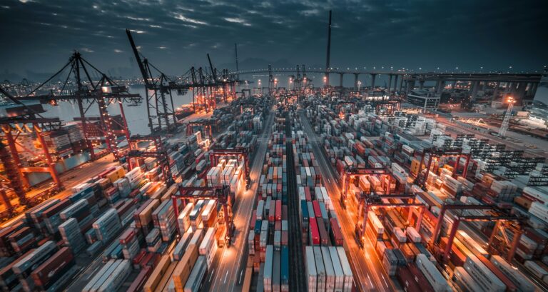 Shipping port with stacked containers and cranes